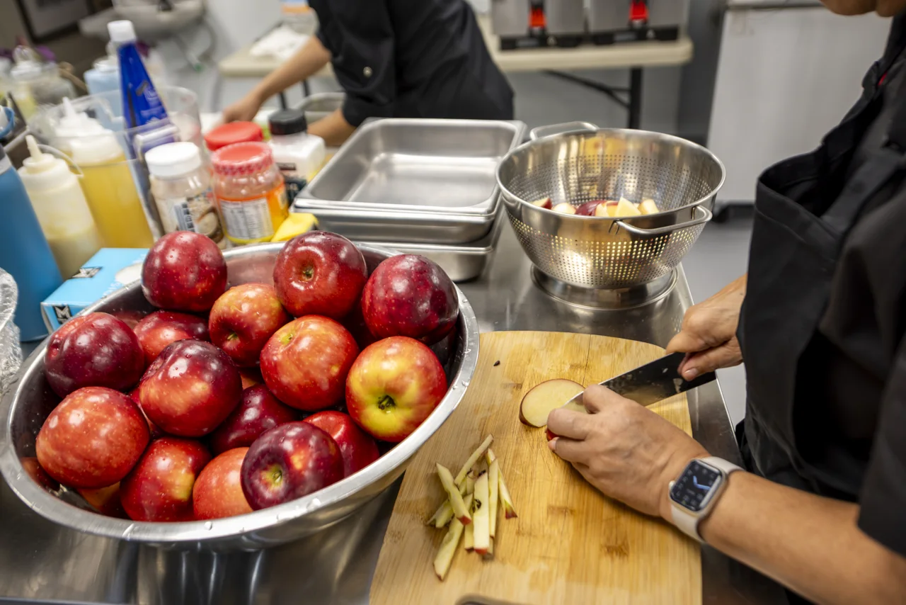 Glossy red apples fill an ingredient tray.
