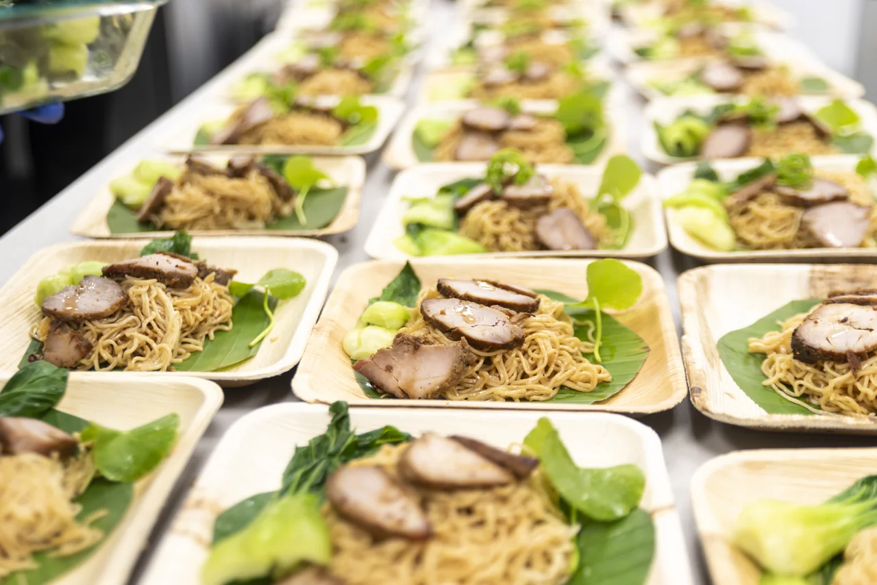 Rows of prepared meat and green garnish wait for service.
