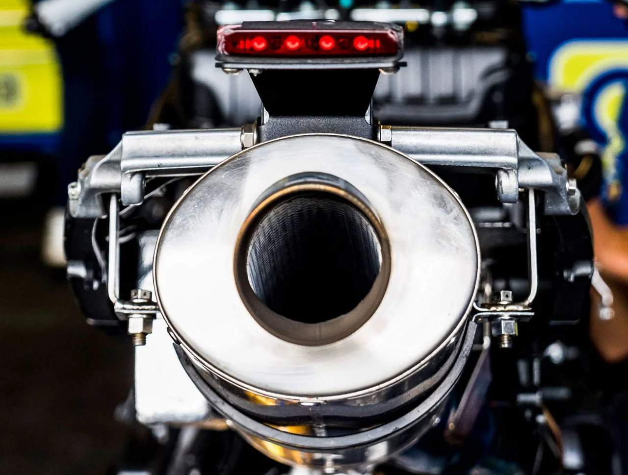 A close view of a motorcycle exhaust and bodywork.