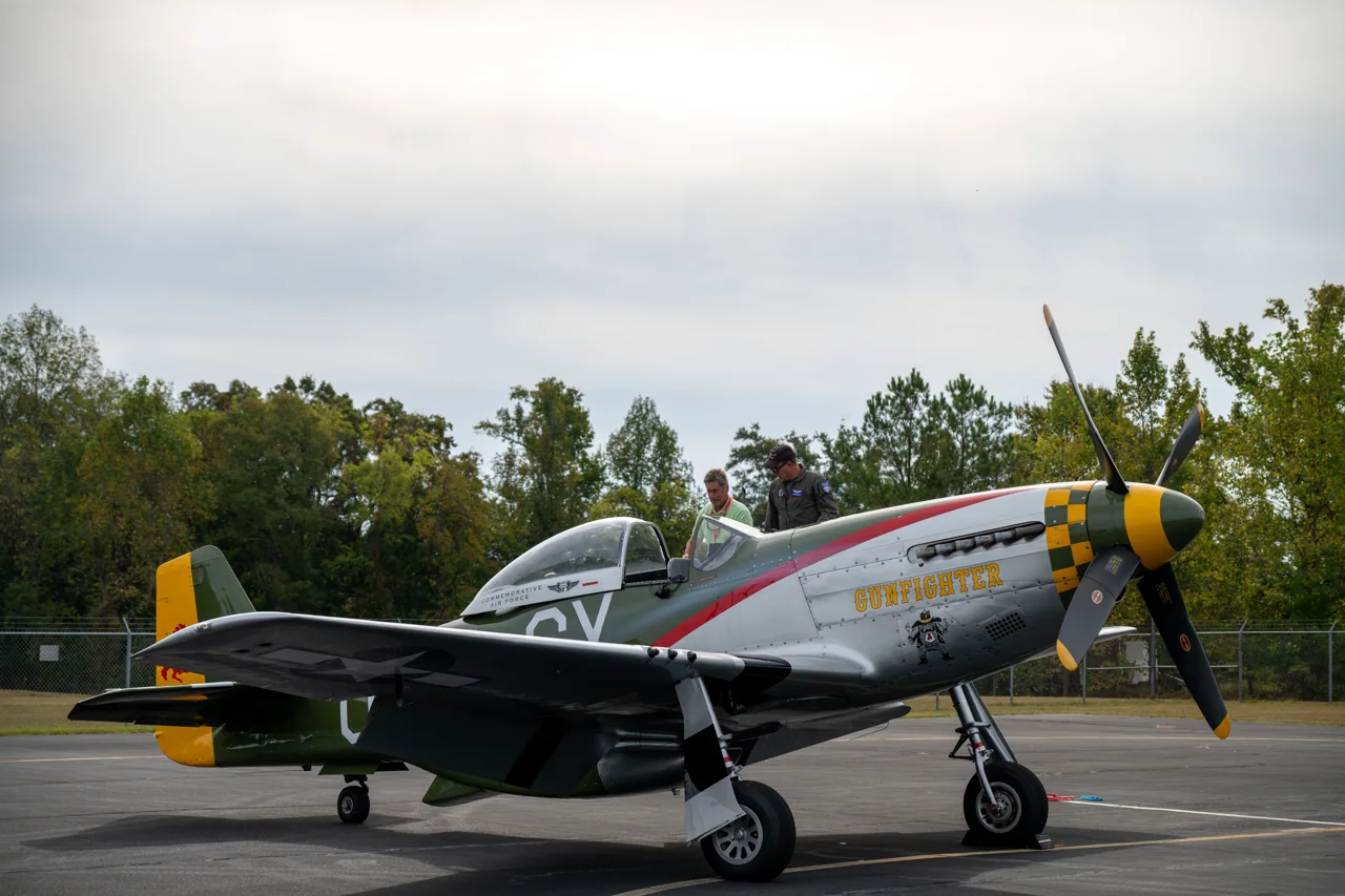 A full vintage aircraft rests on a runway.